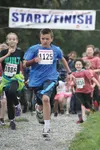 Garret Streit leads the pack during the 12th Annual Running of The Bulls at the Palmer Musk Ox Farm Sunday afternoon. Streit would won the 1K run/walk with a time of 3:51.   BRIAN O'CONNOR/Fr