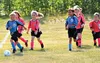 Mielee Merchant leads a group of U-8 Wasilla Youth Soccer players to the edge of the field at the Bumpus soccer complex on Wednesday. Teams break into girls and boys divisions at U-8. KADEN W