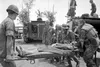 Lt. Thomas Norris stands in the background at center as Lt. Col. Iceal Hambleton (on stretcher) is taken to a waiting M113 armored personnel carrier to be evacuated. (U.S. Department of Defen
