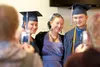 Beryozova School graduates Lukiya Reutov and her cousin Neil Reutov pose for a picture with Neil’s mother, Maria Reutov, before the start of Monday’s graduation ceremony for American Charter 
