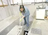 ROBERT DeBERRY/Frontiersman file photo Wastewater treatment
operator Monica Miller scoops out some treated water to conduct a
pH test at the Palmer Wastewater Facility in this 2007 photo.