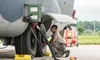 An Alaska Air National Guard aircraft maintainer from the 176th Wing, Joint Base Elmendorf-Richardson, Alaska, inspects the main landing gear tires of a HC-130J Sept. 13, 2018, at Dover Air F