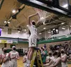 Colony's Hannah Duguid cuts a piece of the net as the Knights celebrate their win in the Northern Lights Conference Championships title game. Tim Rockey/Frontiersman