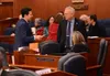 Rep. Neal Foster, D-Nome (left) and Rep. Bryce Edgmon, I-Dillingham (right) talk during a break in the Alaska House floor session on Thursday, Jan. 18, 2024. Seated at right is Rep. DeLena Jo