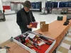 Local gun vendor Roy Hartz attends to his wares at the 2022 Wasilla High School Hockey Booster Club Gun and Outdoor Show. Frontiersman file photo