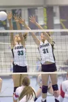 ROBERT DeBERRY/Frontiersman Colony’s Allison Leigh and Mary
Klapperich reach for the block during Thursday’s game against the
West Valley Wolfpack.