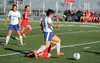 Palmer's Emma Obeso avoids a sliding Wasilla player during a loss to the Warriors last season. Palmer and Wasilla are now in different classes in soccer. Palmer, Houston and Redington are now