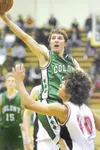 ROBERT DEBERRY/Frontiersman Colony junior guard Doug Gray
reaches over Juneau-Douglas forward Cameron Cook and toward the
basket during the second half of the Knights’ 54-51 win over the
Crim