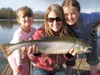 Jehnifer Ehmann along with her step-daughters Kaylee and Callie hold a Dolly Varden they caught in Finger Lake. Photo courtesy Butch Ehmann