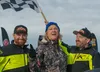 Iron Dog 2025 winners Brad George, left, and Robby Schachle, right, pose with Lt. Gov. Nancy Dahlstrom, center, at the finish in Big Lake Saturday. J. David McChesney/Frontiersman