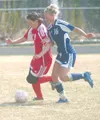 Wasilla’s Maija Kellner-Rode brings the ball up the field past
Soldotna’s Kali Sholin during the second half of the Warriors’ 1-0
win over the Stars at Wasilla High School on Saturday morning