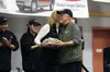 Four-time Iditarod Trail Sled Dog Race champion Jeff King receives a gold pan full of cash for being the first musher to reach the Yukon in the 2016 Iditarod during the post-race banquet in N
