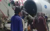 Afghan evacuees board a U.S.-chartered flight for their destination after a two-week stay in Kuwait, where they received medical screenings and were processed by Task Force Spartan personnel.