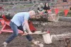 GREG JOHNSON/Frontiersman AJ Clauson follows uses his whole body
to split a birch log during the wood splitting contest at the
Homesteader Games.