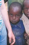 A young girl, born at Kiziba Refugee Camp, holds the hand of her
visitor while keeping her brother close by. Photo by KATELYN
BALDWIN/Special to the Frontiersman,