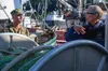 Rear Adm. Scott Gray, commander of Navy Region Northwest, learns about local commercial fishing processes from John Renner, a commercial fisherman in Cordova. Gray was in Alaska along with ap
