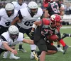 Houston’s Apete Sasiu breaks a tackle and runs for a long gain during a loss to Eagle River Friday. Sasiu led the Hawks with 86 yards rushing. Jeremiah Bartz/Frontiersman.com