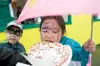 ROBERT DeBERRY/Frontiersman Audrey Williams takes a bite of a
fresh funnel cake Saturday.