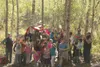 Students from the Machetanz Elementary nature club look on as Jayson Smart of the Rasmuson Foundation cuts the ribbon on the new Wasilla Wetlands Trail off Nelson Road on Thursday, May 12, 20