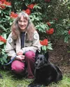 Sage the search and rescue dog poses with handler Stacie Burkhardt. The pair were together 15 years, finding four living people and the remains of nine more in that time. Sage died in Decembe