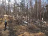 This submitted photo shows Valley Center for Recycling Solutions director Molly Boyer behind the center with a myriad of plastic bags in the nearby woods. There is an effort underway to eithe