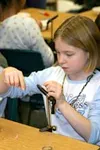Larson Elementary School student Tiffany Hardwick ties a fly
Thursday morning. Hardwick's class is one of many that are
participating in the STREAM program, which introduces students to
the l