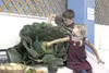 Elsa Rodriguez, 4, and 9-year-old brother Eli adjust a 25-pound cabbage they grew after placing it in the Machetanz Elementary School exhibit Wendesday at the agriculture barn at the Alaska S