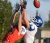 Kenai Central's Braedon PItsch can't hold on to a pass under pressure from Palmer's Makeehan Knittle on Friday, Aug. 24, 2018, at Ed Hollier Field in Kenai. (Photo by Jeff Helminiak/Peninsula