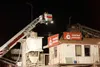 (ROBERT DeBERRY/Frontiersman) Mat-Su Central fire fighters use
the big ladder truck to gain access to the upper area at Consteel
Concrete Friday evening.