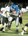 Palmer’s David Schneider pushes for yardage during last week’s win over the South High School Wolverines. Palmer takes on the West High School Eagles tonight at the Anchorage Football Stadium