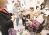 ROBERT DeBERRY/Frontiersman Missie Hansen, left, listens as
94-year-old Margaret Carnes, right, shares her thanks for a basket
of gifts from the women at the Curves for Women in Wasilla.
Watc