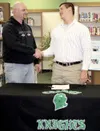 Photo courtesy of Colony High School Colony senior Dakota
Wainwright, right, shakes the hand of Colony head football coach
Brian McIntosh after Wainwright signed his National Letter of
Intent