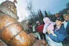 Barb Redington and 13-month-old Raynee Redington admire the
statue of Joe Redington Sr. Saturday following the dedication
ceremony.WILLIAM WOODY/Frontiersman