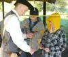 J.J. HARRIER/ Frontiersman Zach Shumaker, 16, left of Boy Scout
Troop 367 shows two Webelos how to use a stone and steel striker to
make sparks to start a fire. Shumaker was one of many Boy S