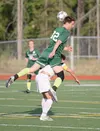 Colony senior Brett Hintz lands on a South Anchorage player after he goes up for a header during a 5-0 loss to the Wolverines in the first round of the ASAA state soccer tournament May 28. Co