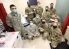 U.S. Airmen with the 673d Medical Group pause for a photo after preparing to administer the COVID-19 vaccine at Joint Base Elmendorf-Richardson, Alaska, Dec. 31, 2020. Upon receiving the init