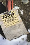 A gate blocks the driveway leading to a house owned by Loren K. Dodds, which has been seized in the aftermath of Dodds’ third conviction for growing marijuana. A note on this sign attached to