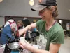 Chugach Farm’s Allie Barker pours a sample of kombucha, a fermented drink of sweetened black tea, Friday at the Valley Winter Farmer’s Market and Food Day Celebration in Palmer. ROBERT DeBERR