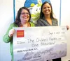 The Children’s Place Family Advocate Paula Jones accepts a $1,000 donation from Wells Fargo Mat-Su District Manager Aryne Randall. Courtesy photo