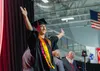 Houston High School 2025 graduation master of ceremony Terje McClurg plays to the crowd as he walks across the stage to receive his diploma. J. David McChesney/Frontiersman