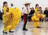 Fronteras Spanish Immersion Charter School students perform a Mexican dance at the Mat-Su Bridge Builders 'World Flavors' potluck at Mat-Su Career and Technical High School on Saturday. CAITL