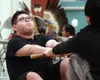 Joe WIllson of the Wasilla High Native Youth Olympics Team grimmaces as he demonstrates the Eskimo stick pull event during the 2016 Native Youth Festival at Mat-Su Career and Technical High i