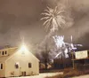 Fireworks explode in the sky above the Matanuska Maid building
Saturday night during the Colony Christmas festivities. Photo by
SCOTT CHRISTIANSEN/Frontiersman.