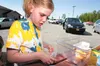 Annabelle Ochap puts a lid on her lunch Monday afternoon at The Children’s Lunchbox location at the Food Pantry of Wasilla. Robert DeBerry/Frontiersman.com