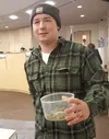 Robert Brown holds marijuana he brought with him to the Mat-Su Borough Assembly meeting Tuesday. Brown — who brought the weed because he "always wanted to" — says he hopes the industry will r