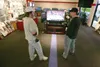 (ROBERT DeBERRY/Frontiersman) Mike Pendergraft, left, talks
televisions with Shimek's Service Tech Tim Ellis Friday afternoon.
According to Shimek's store manager Steve Burress Black Friday h