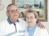 Miles and Donna France relax in their Palmer home Wednesday.
Behind them is a painting of their homestead, which was done by
their daughter, Sandra Nichols. Photo by CASEY
RESSLER/Frontiersma