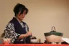 University of Alaska Anchorage professor Yuki Moore spoons powdered green tea into a bowl given to her by her grandmother during a tea ceremony demonstration at United Protestant Presbyterian