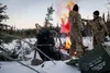 U.S. Air Force master sergeants James Cain (left) and Justin Streitberger use MK-124 signaling flares at their ground-to-air signal (GTAS) area in the Arctic field training area on Eielson Ai