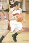 ROBERT DeBERRY/Frontiersman Houston’s Ryan Contreras moves the
ball across the court during the second half of the Hawks’ loss to
Ketchikan.
